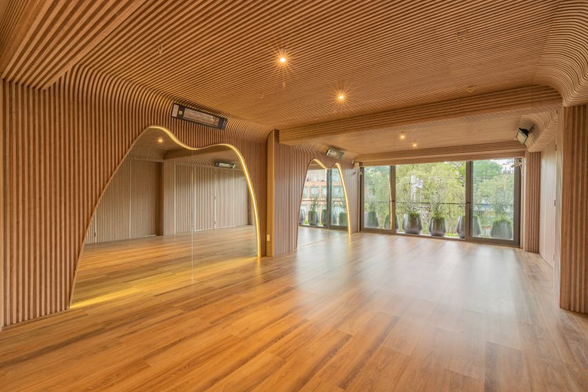 The exercise space at Align Studio is wrapped in oak slats