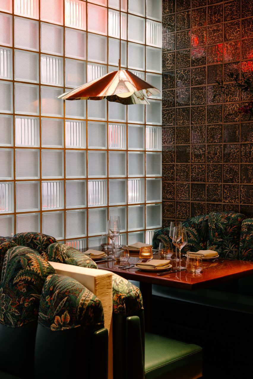 Booth seating next to a textured glass brick wall