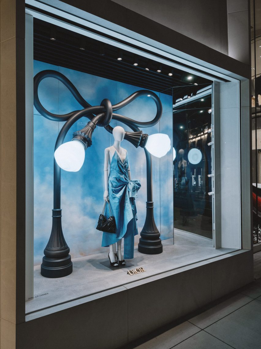 Dior window displays by Alex Chinneck showing two entangled street lights