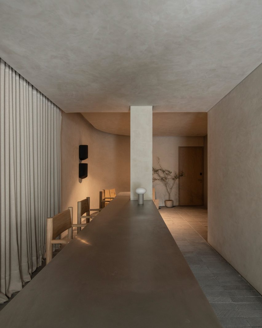A long table anchored by a structural column forms a reception desk