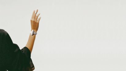 Person wearing the Nura bracelet, a wearable device designed to translate sign language into speech