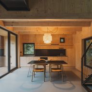 Dining and kitchen area of log cabin in forest