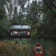 Wood cabin with river kayak