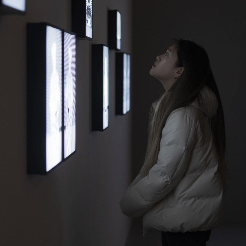 a person viewing screens on a wall