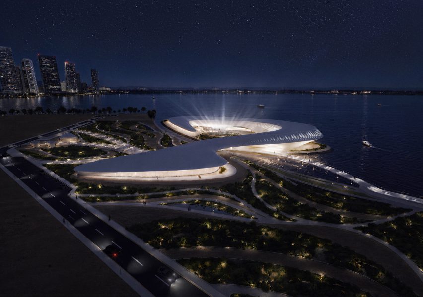 Architectural render of an organic-shaped building amongst a cityscape on the waterfront.
