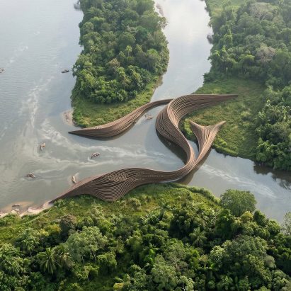 Aerial render of a snaking architectural building that acts as a bridge between three nearby land masses.