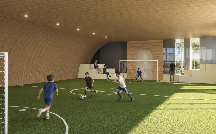 Computer-generated image of an indoor football area, with children playing.