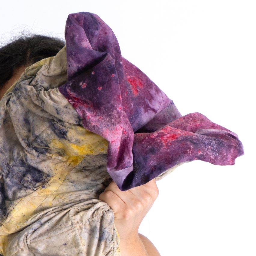 Image of a person holding a piece of folded material.