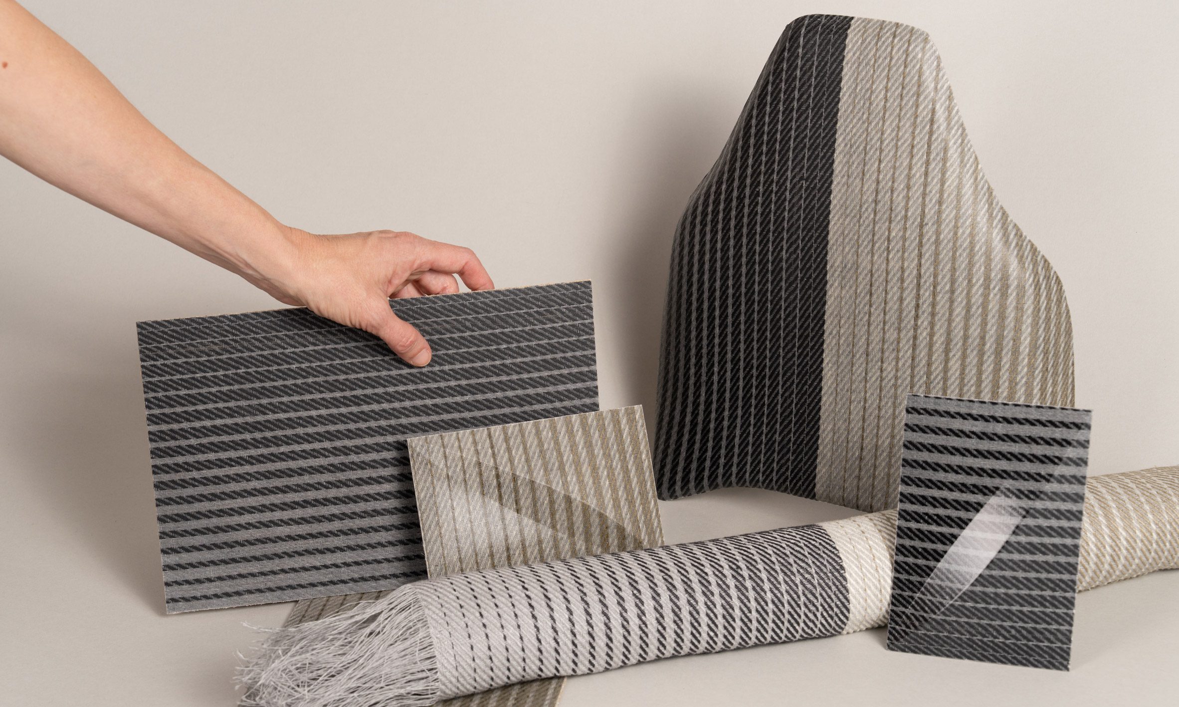 Image of different pieces of grey-striped fabrics.