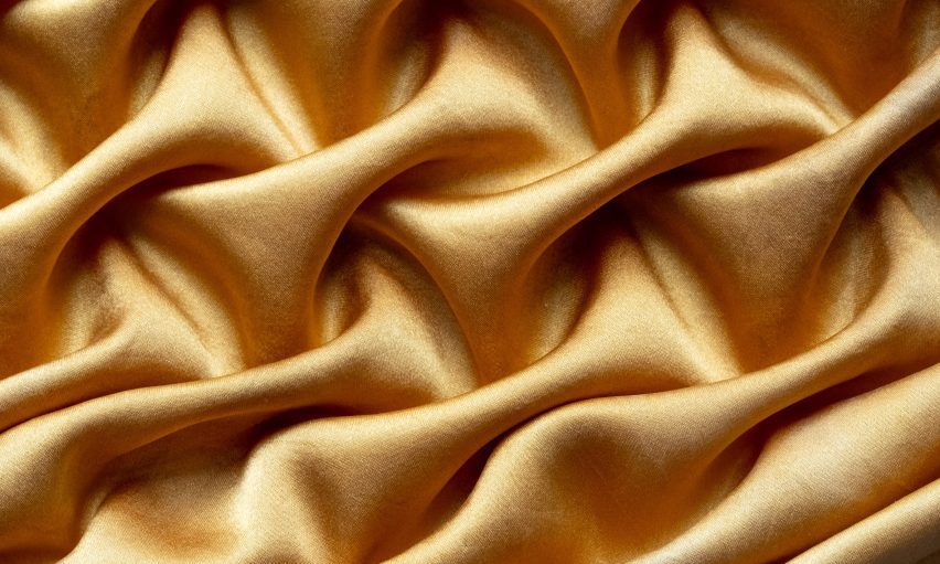 Image of a gold, silky fabric.