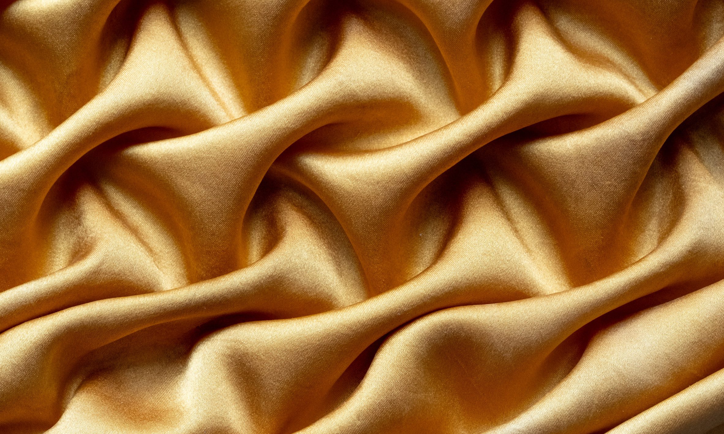 Image of a gold, silky fabric.