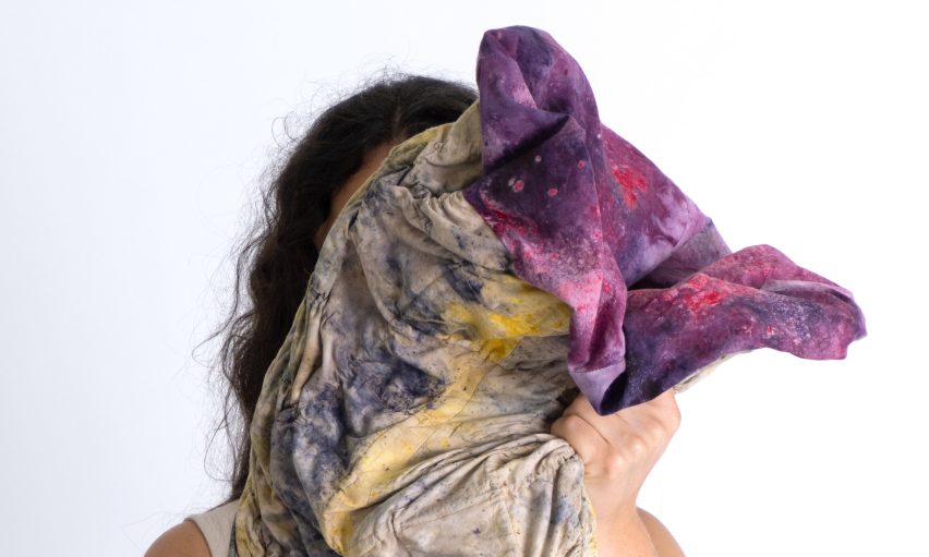 Image of a person holding a piece of folded material.