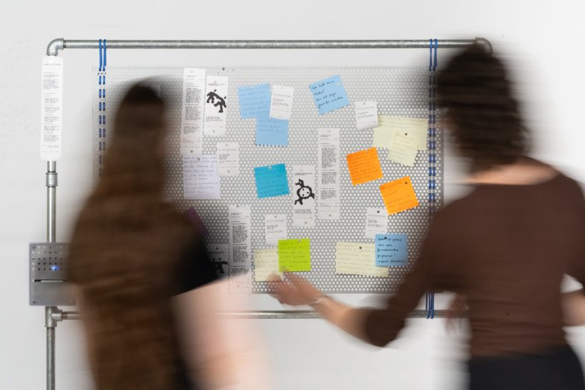 Photo of people in front of a pinboard
