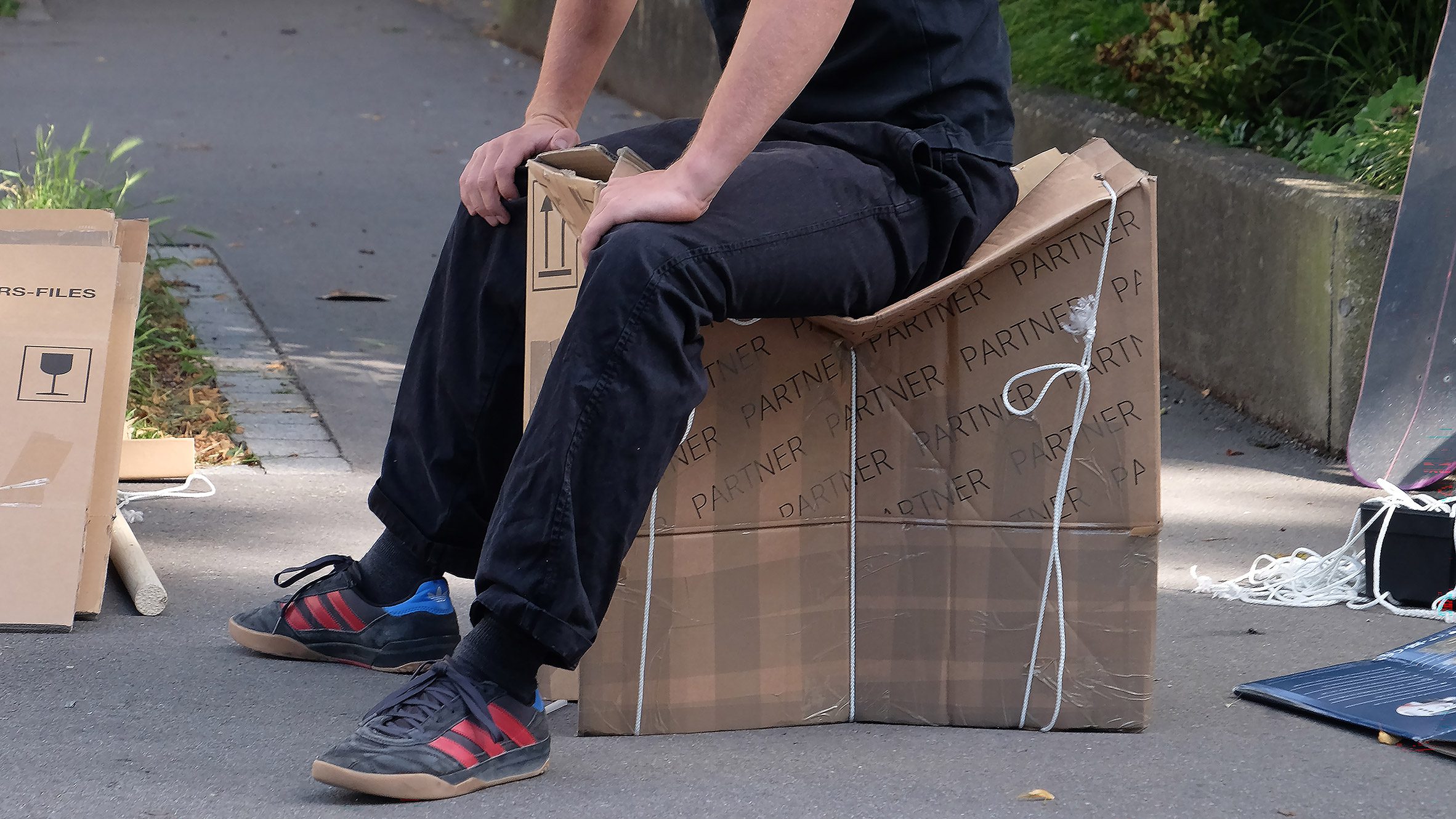 Photo of person sat on a box