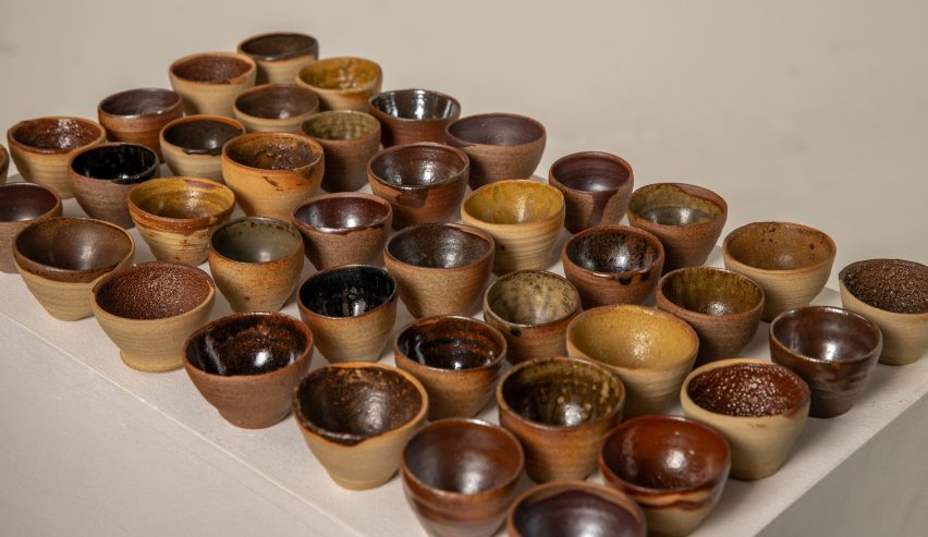 A series of small brown ceramic pots