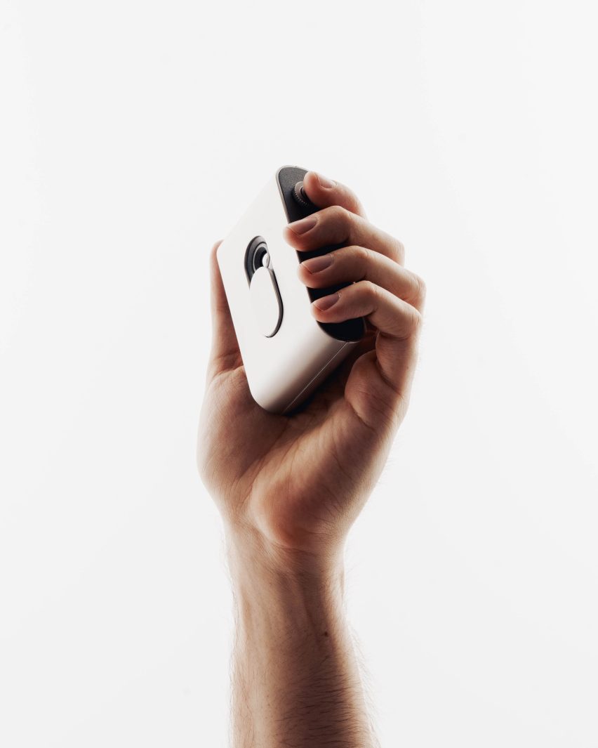 A hand holding up a digital recording system
