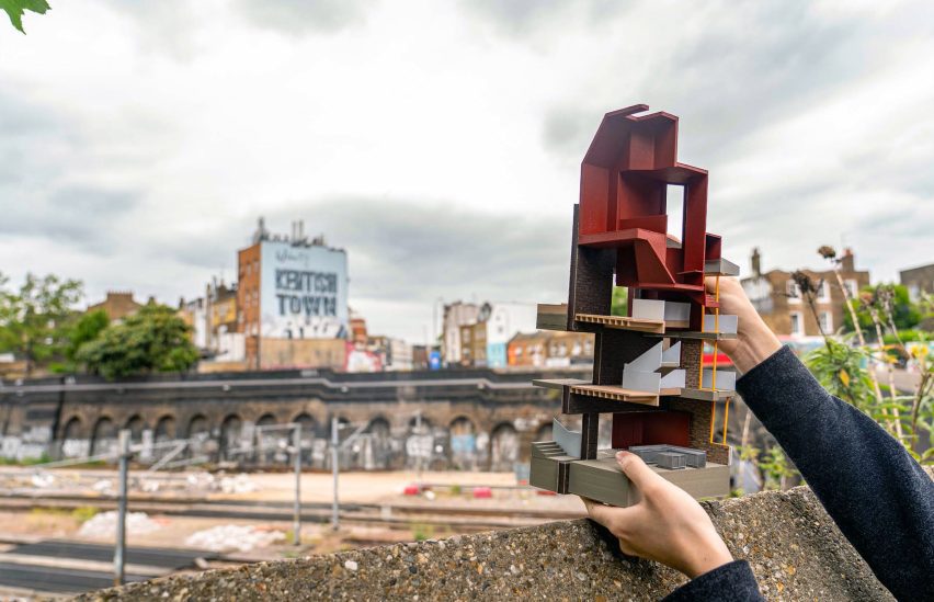 Photo of person holding up an architecture model