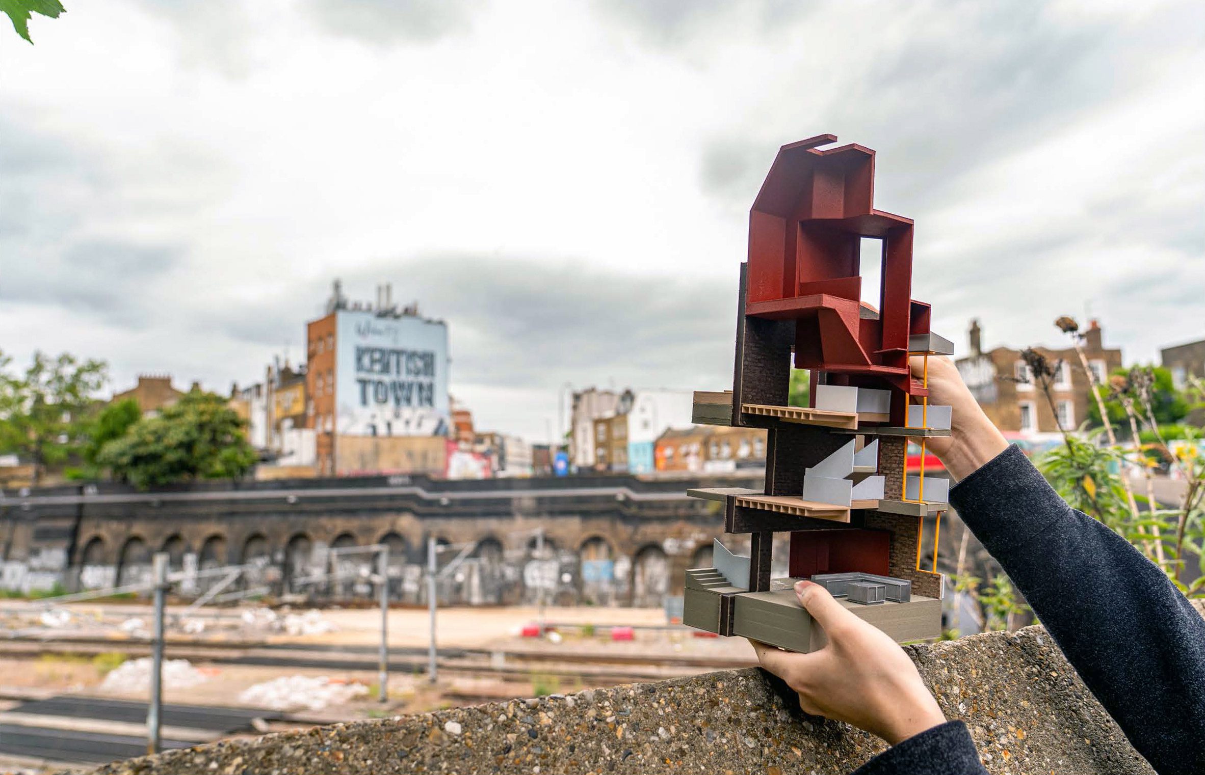 Photo of person holding up an architecture model