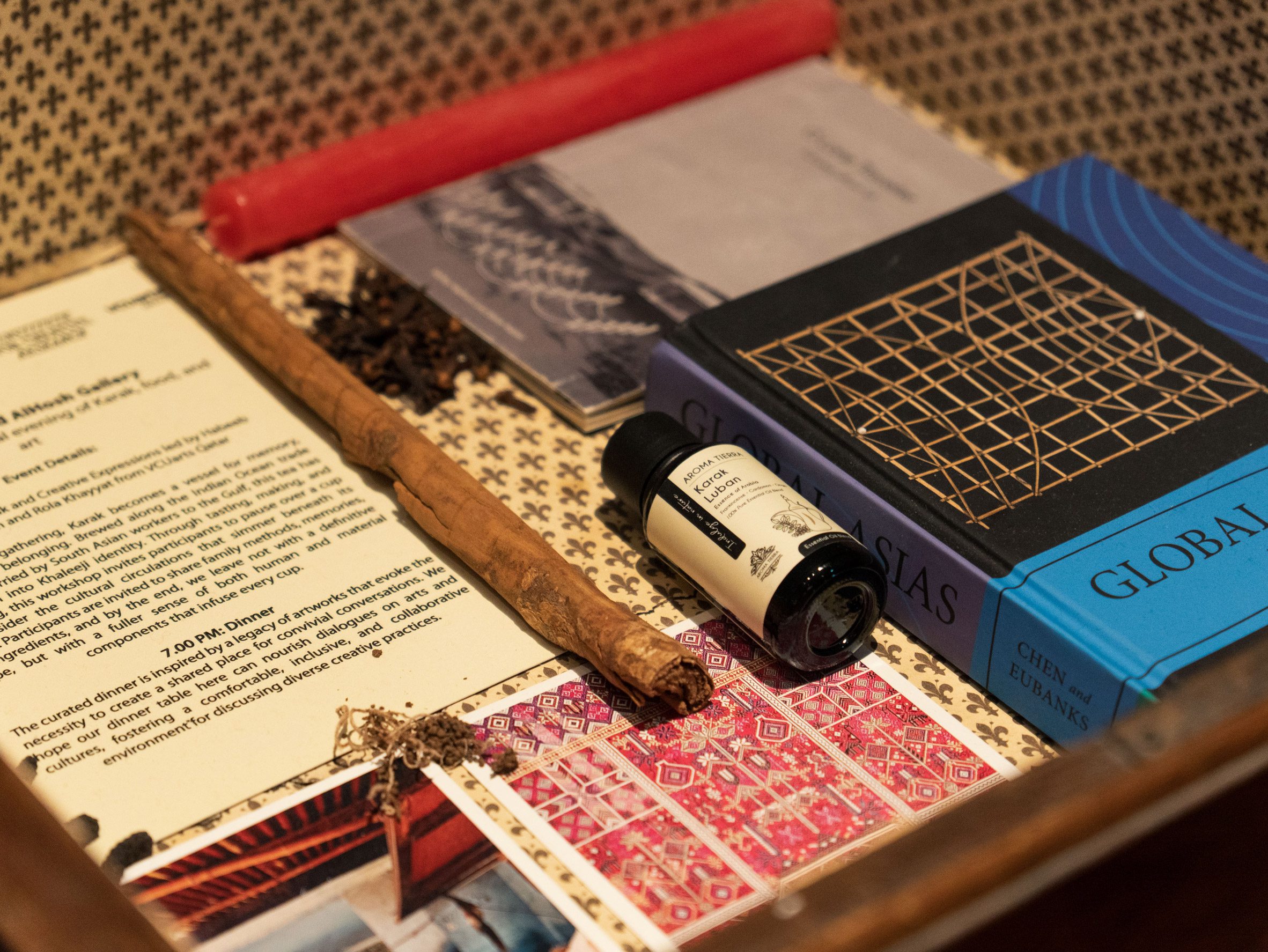 Photo of objects, including a book, candle and paper
