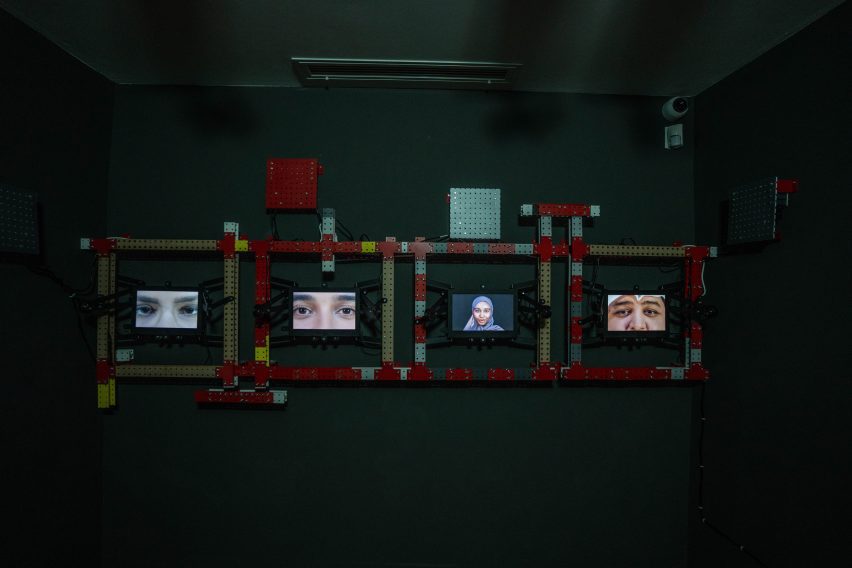 Photo of an exhibition with close up images of people's faces