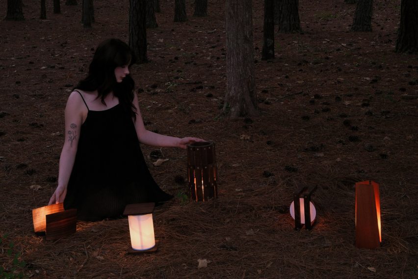 Photo of person in woodlands with lanterns