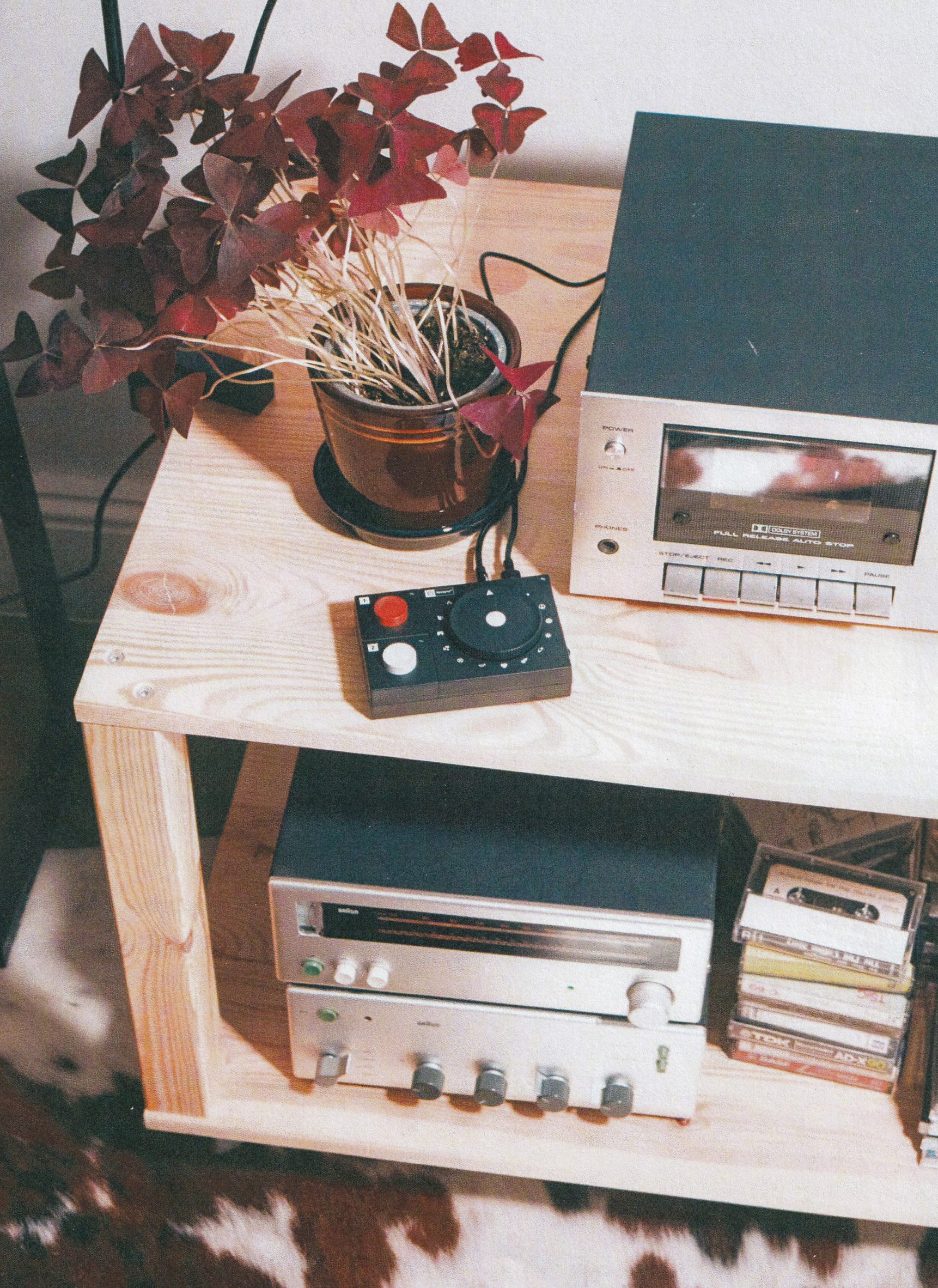 Grainy photo of the Atonemo NTS Radio Player plugged into a hi-fi system in a home