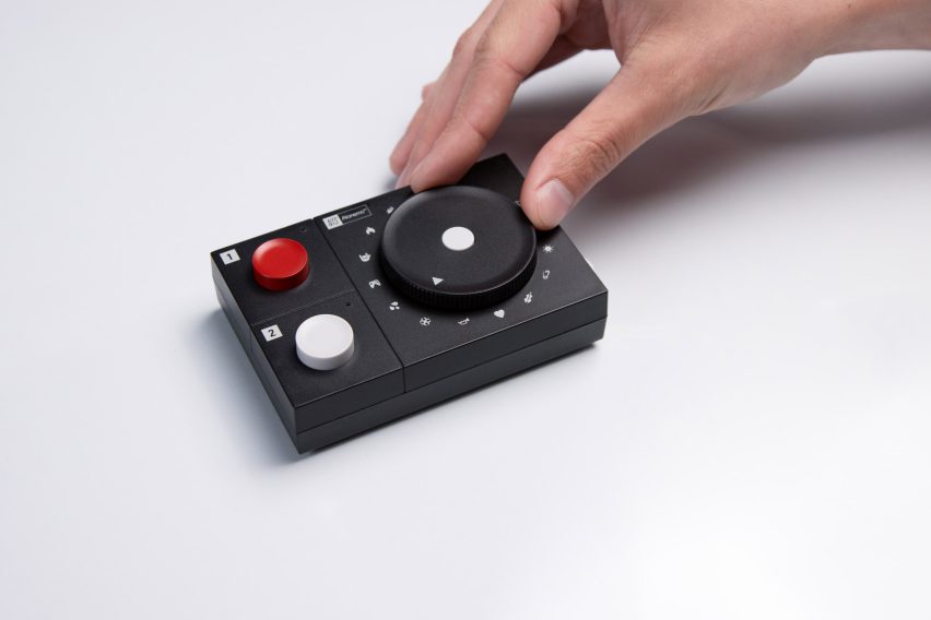 Photo of the Atonemo NTS Radio Player with a hand turning the wheel so it points to one of 16 small icons
