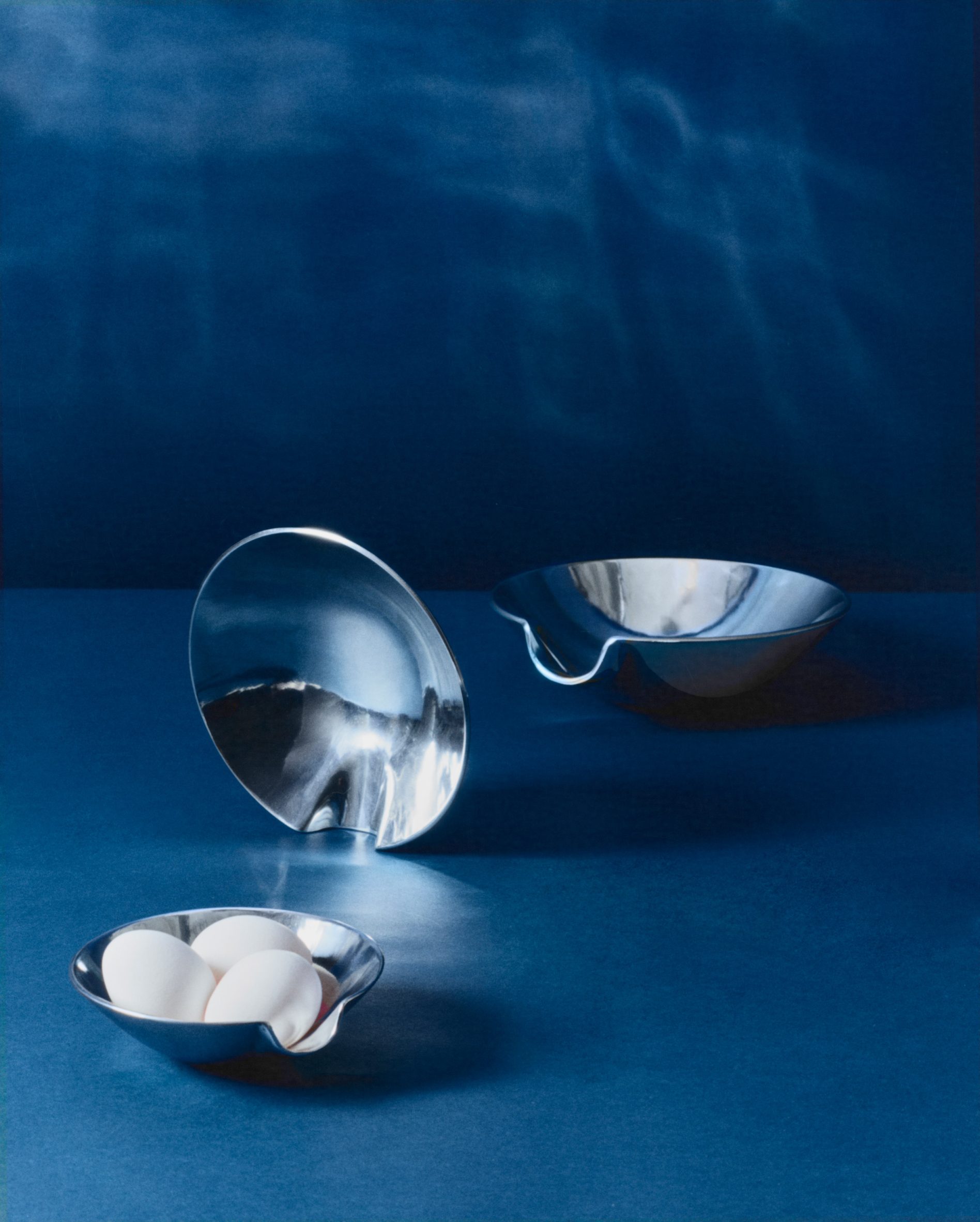 Metal bowls with eggs in them