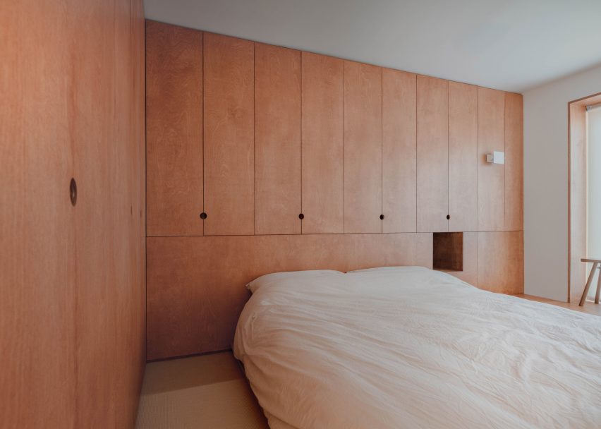 Birch plywood forms floor-to-ceiling storage in a primary bedroom
