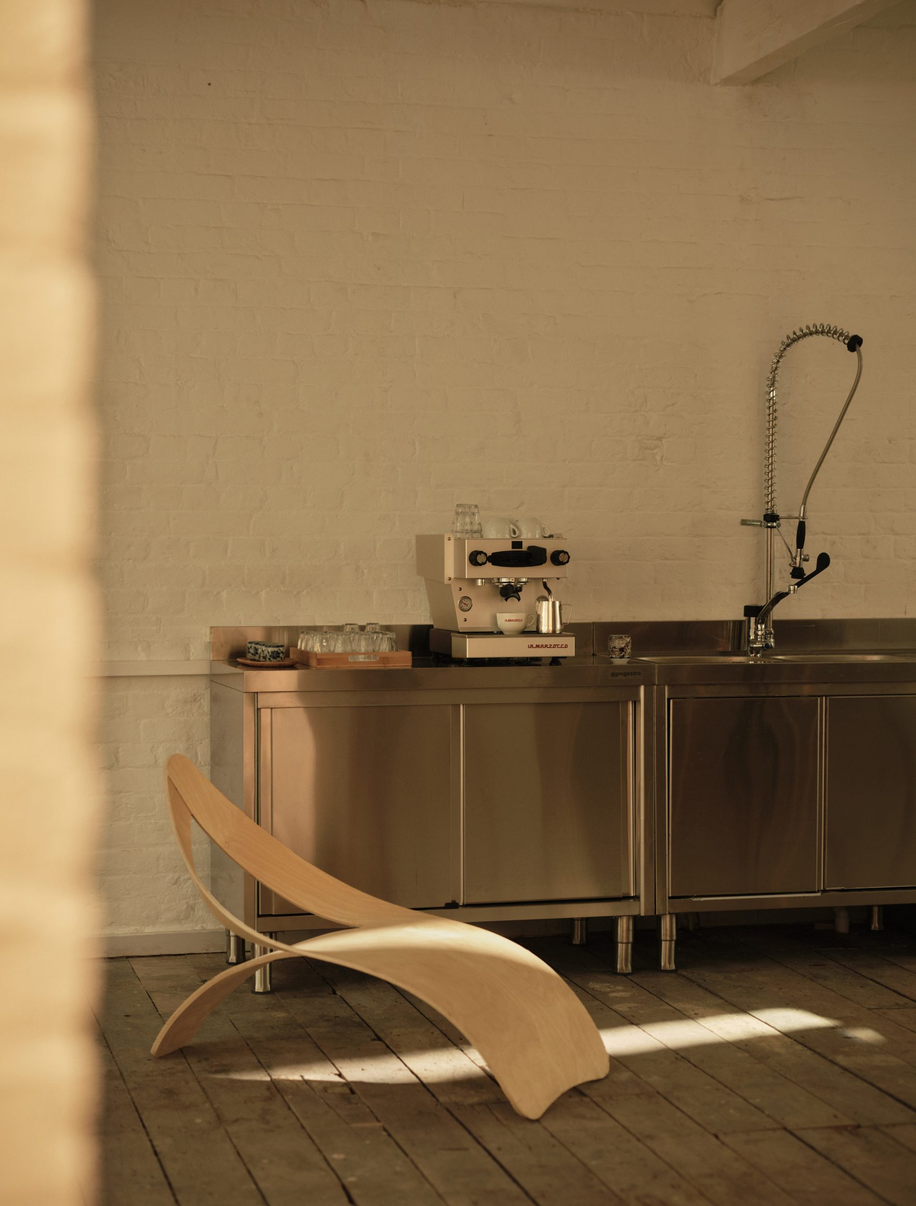 Stainless-steel kitchen in The Yard by 51 Architecture