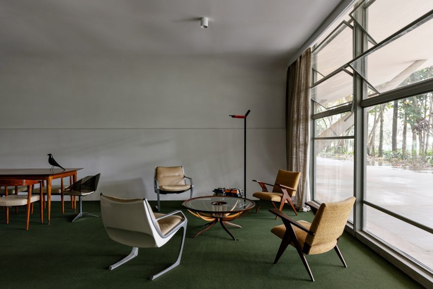 A display of modernist Brazilian furniture in a green-carpeted room