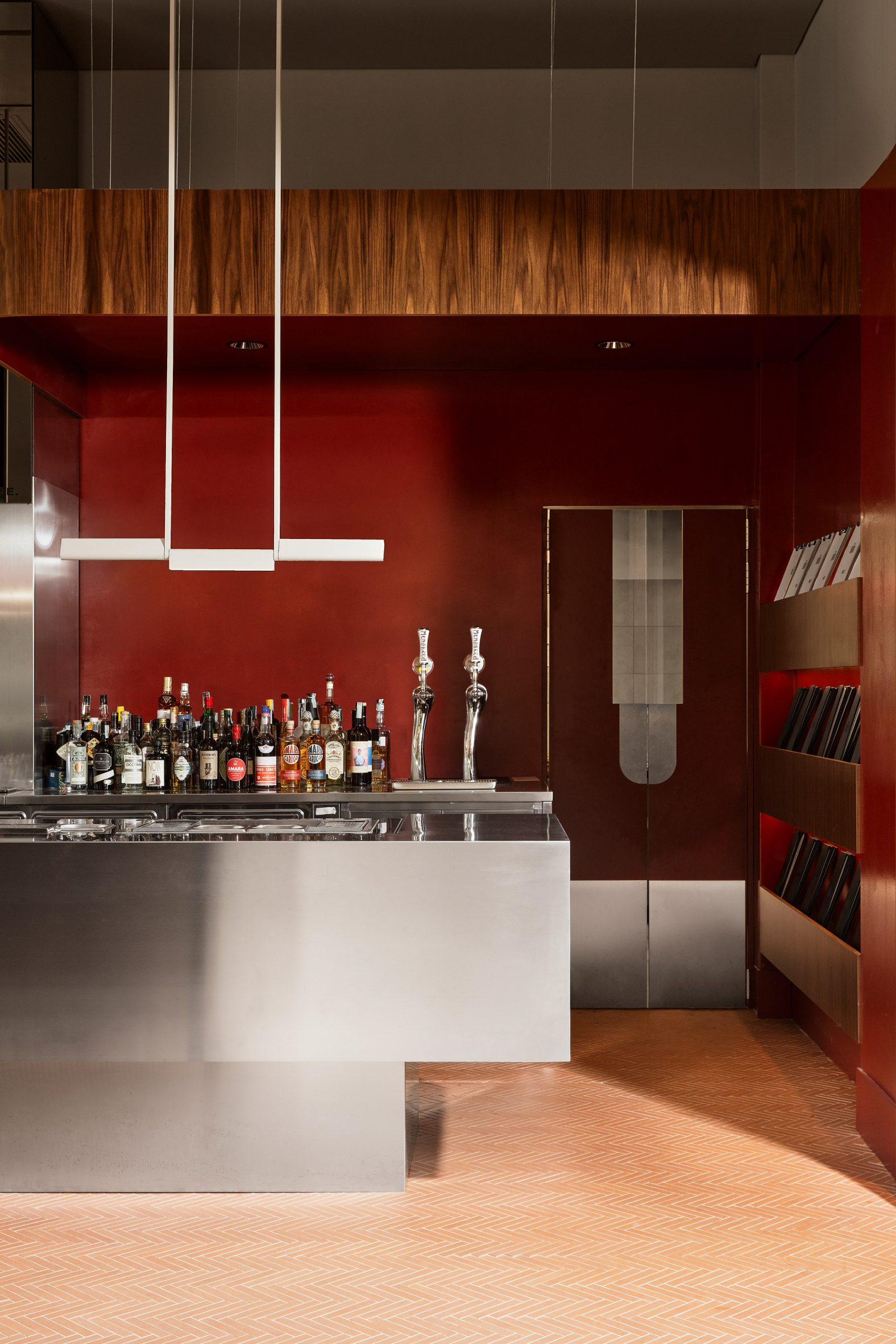 Bar with stainless steel counter and red wall behind
