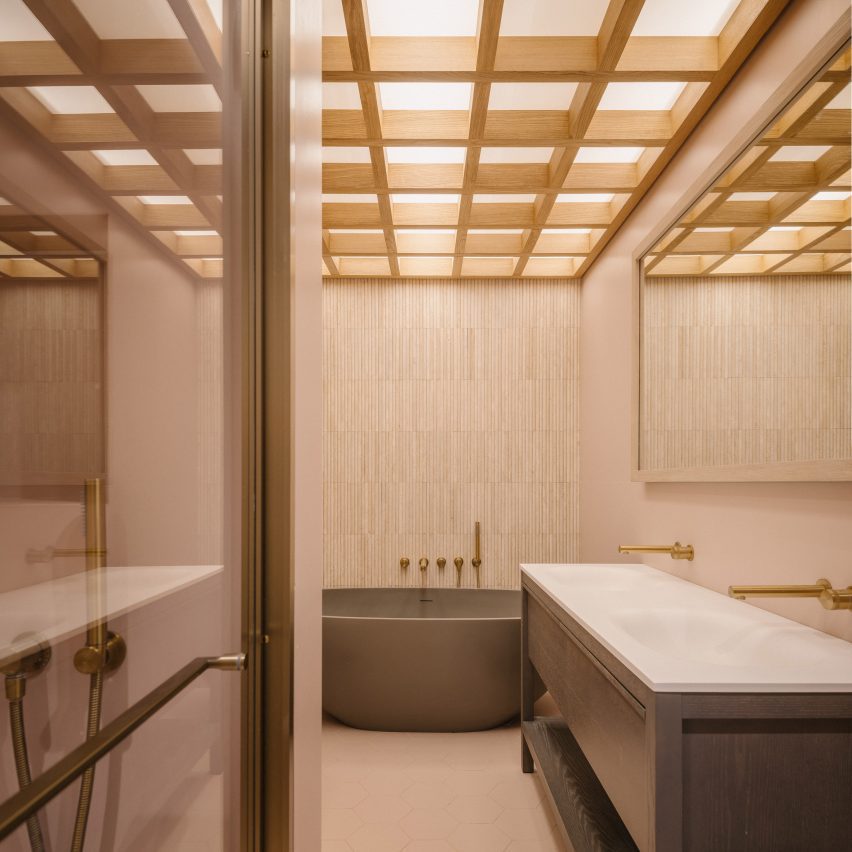 Bathroom featuring a freestanding bath and timber ceiling detailing