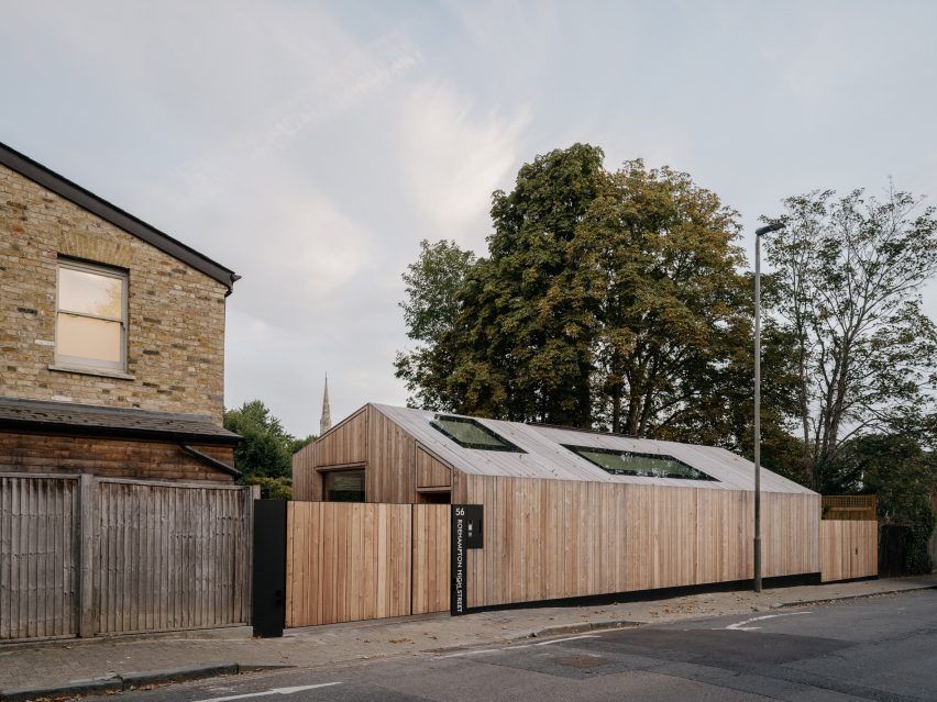 Street-facing view of the partially submerged house behind a timber fence