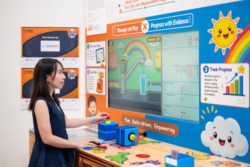 Person interacting with brightly-coloured wall display