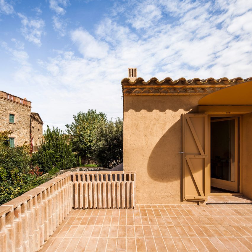 Upper-floor terrace finished with terracotta flooring and brick balustrades
