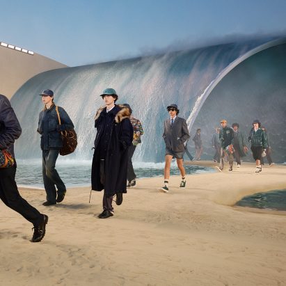 Models in front of large wave at Louis Vuitton show