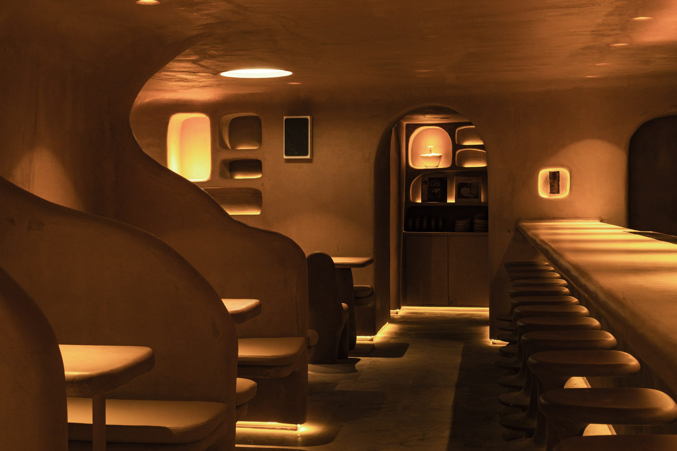 A series of banquettes divided by sculptural partitions