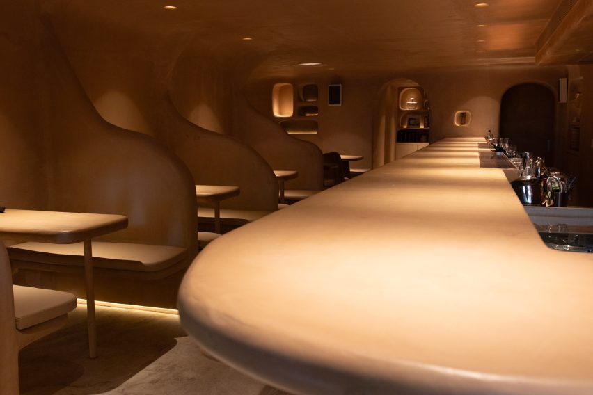 Spotlights illuminate a bar counter and tables