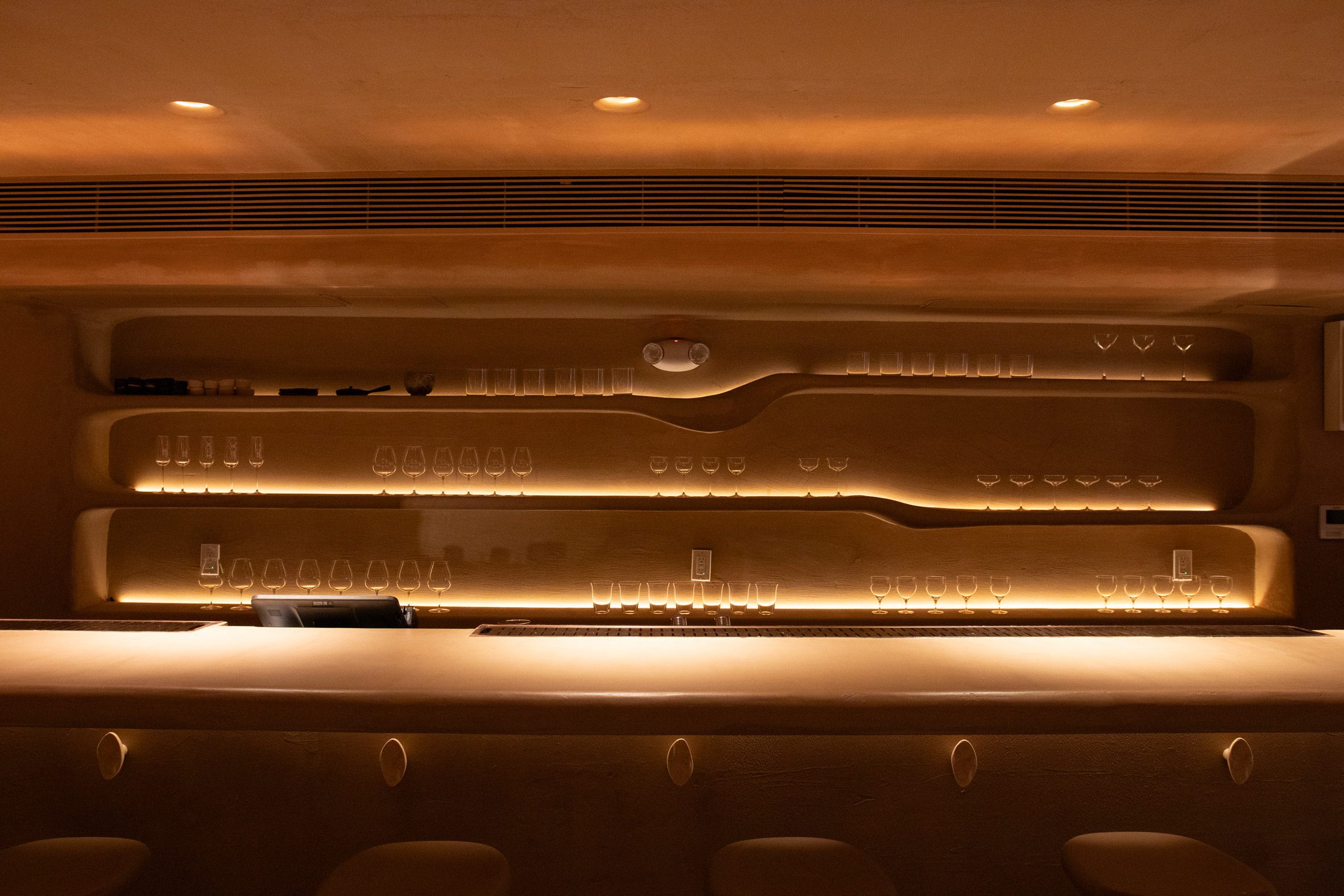 Shelves behind a bar with dips and slants