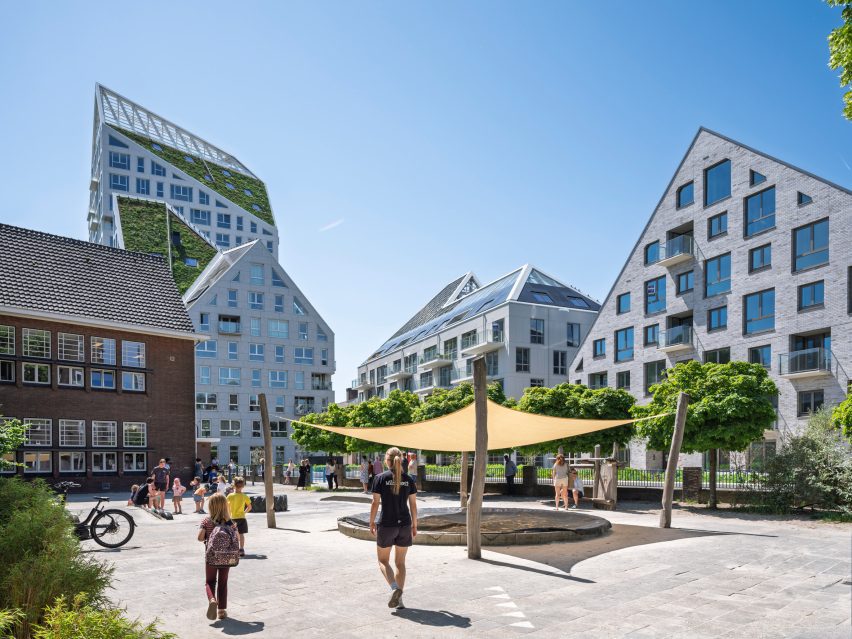 People walking through residential complex by MVRDV