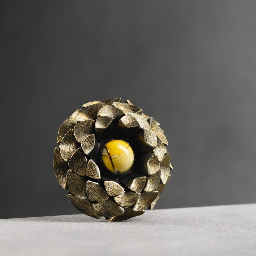 image of a gold and yellow brooch