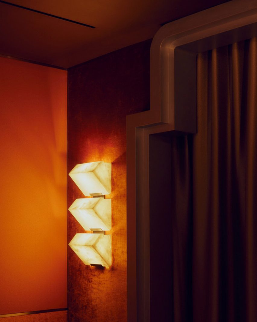Triangular light next to cinema curtain