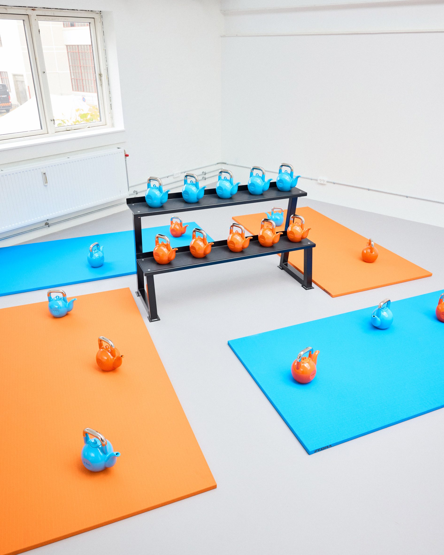 Kettlebell teapots in blue and orange