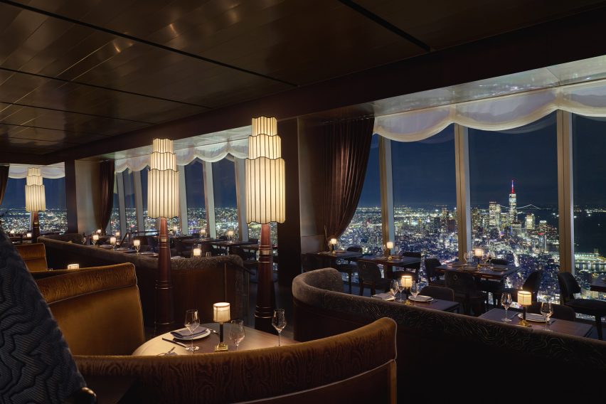 Restaurant with tiered lighting and NYC skyline view