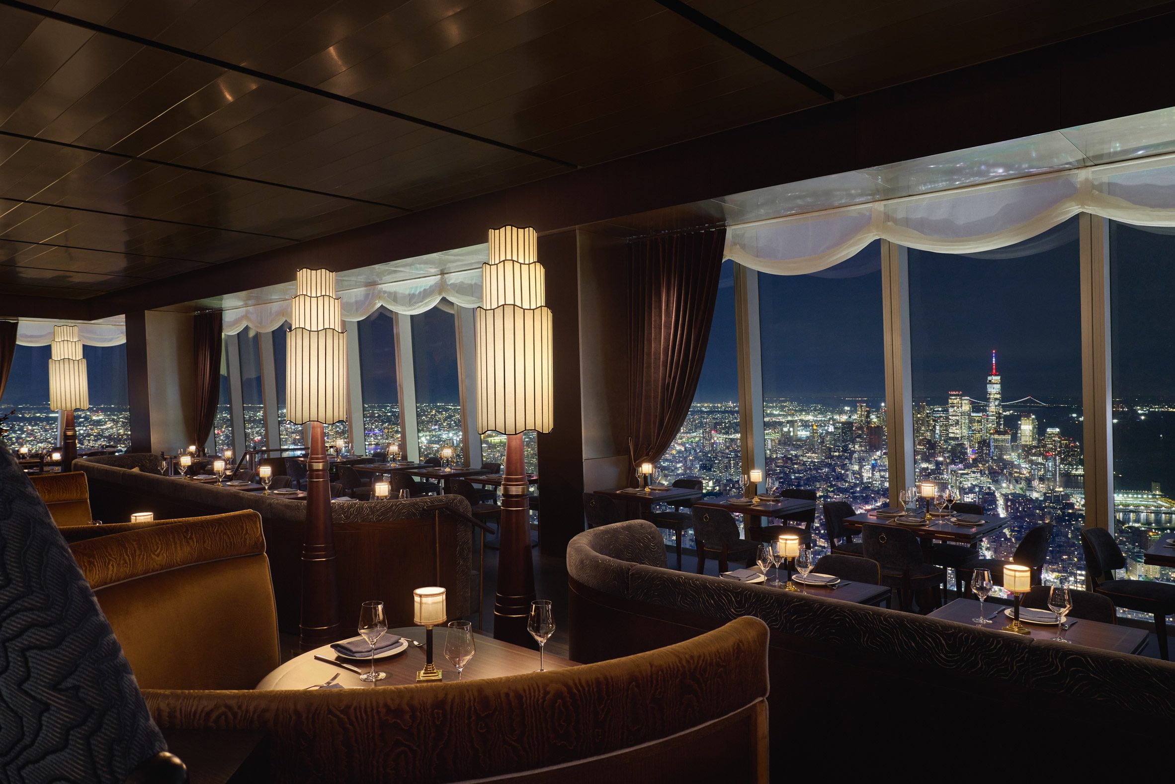Restaurant with tiered lighting and NYC skyline view