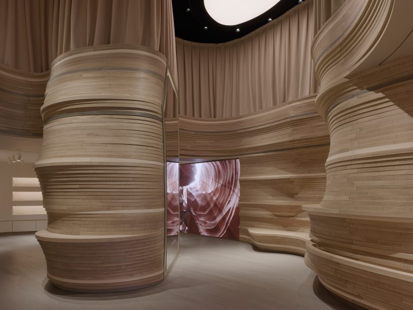 An LED wall display within a wood-wrapped store interior