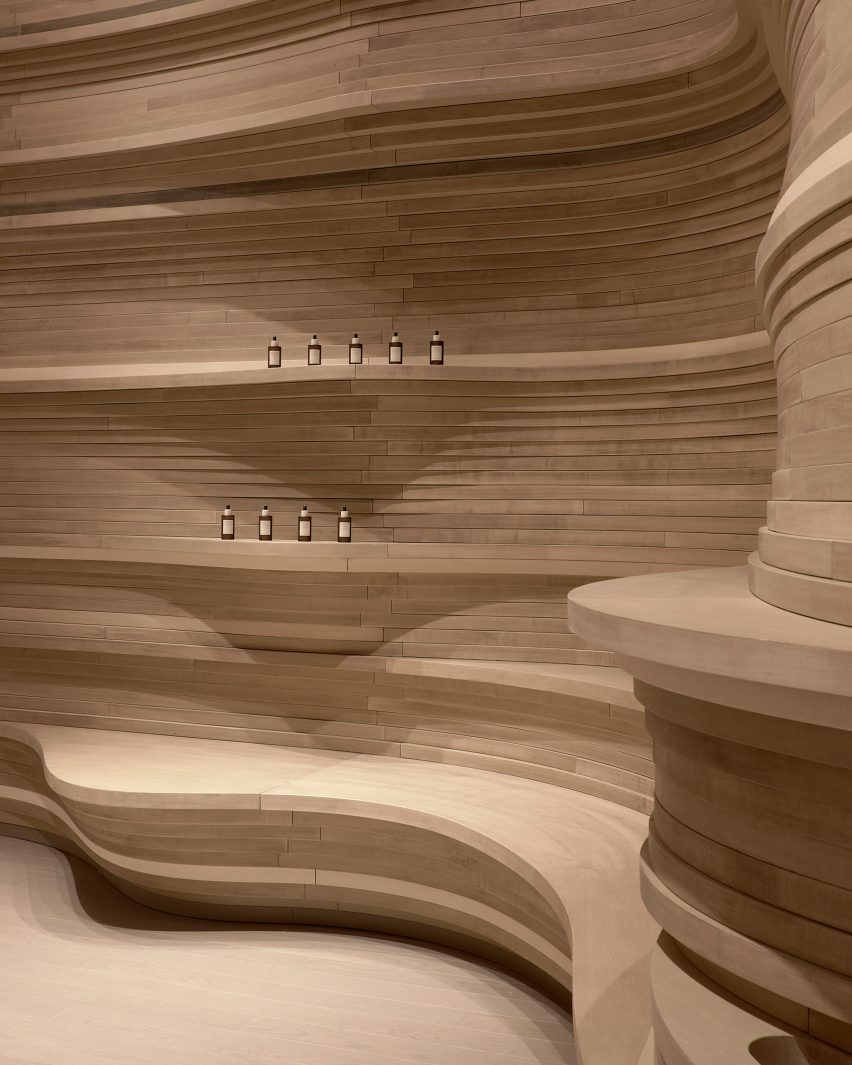 Undulations in wooden layers create seats and shelves