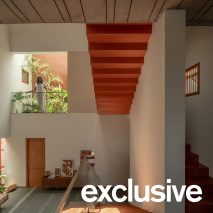 Orange staircase connects levels of Splitscape Residence in India