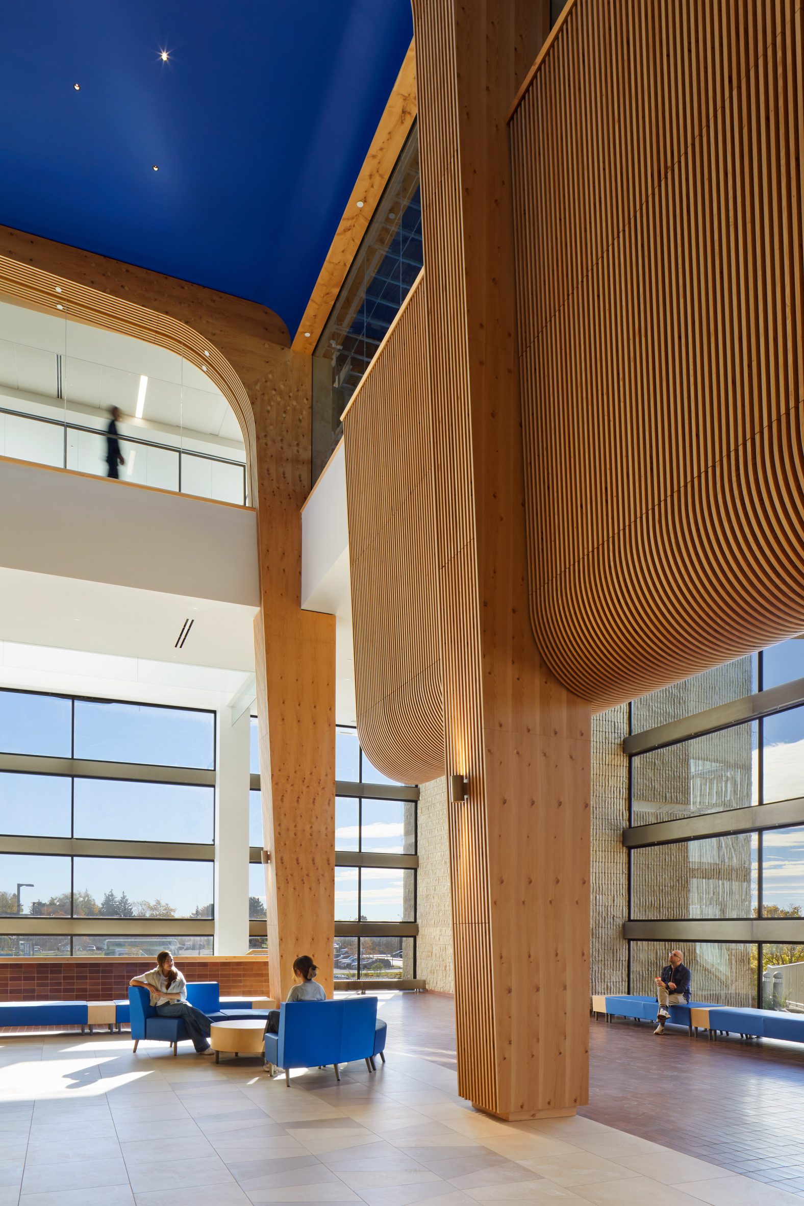 Structural columns wrapped in wooden fins to evoke the tall pines trees